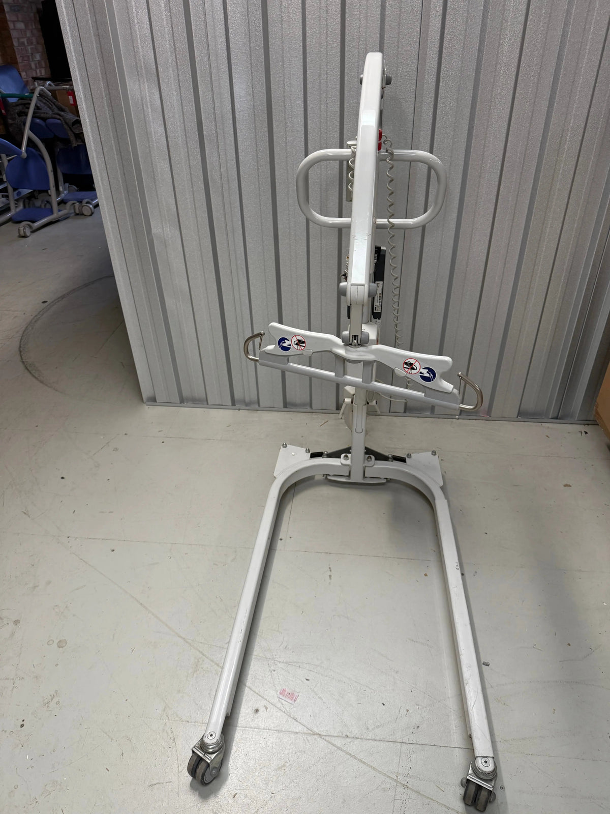 Front view of patient lift showing adjustable leg width