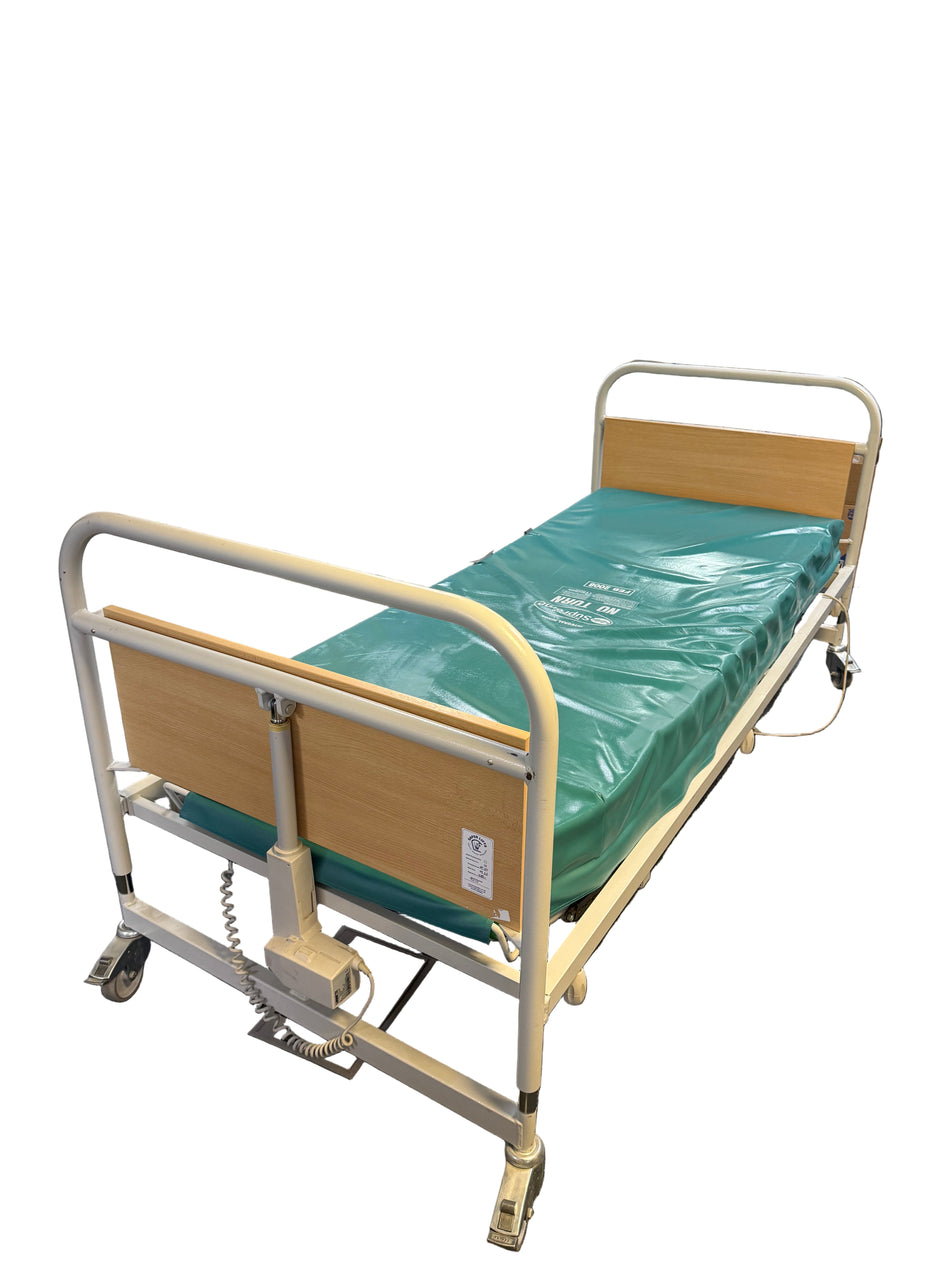 Hospital bed in a room with medical equipment and supplies.