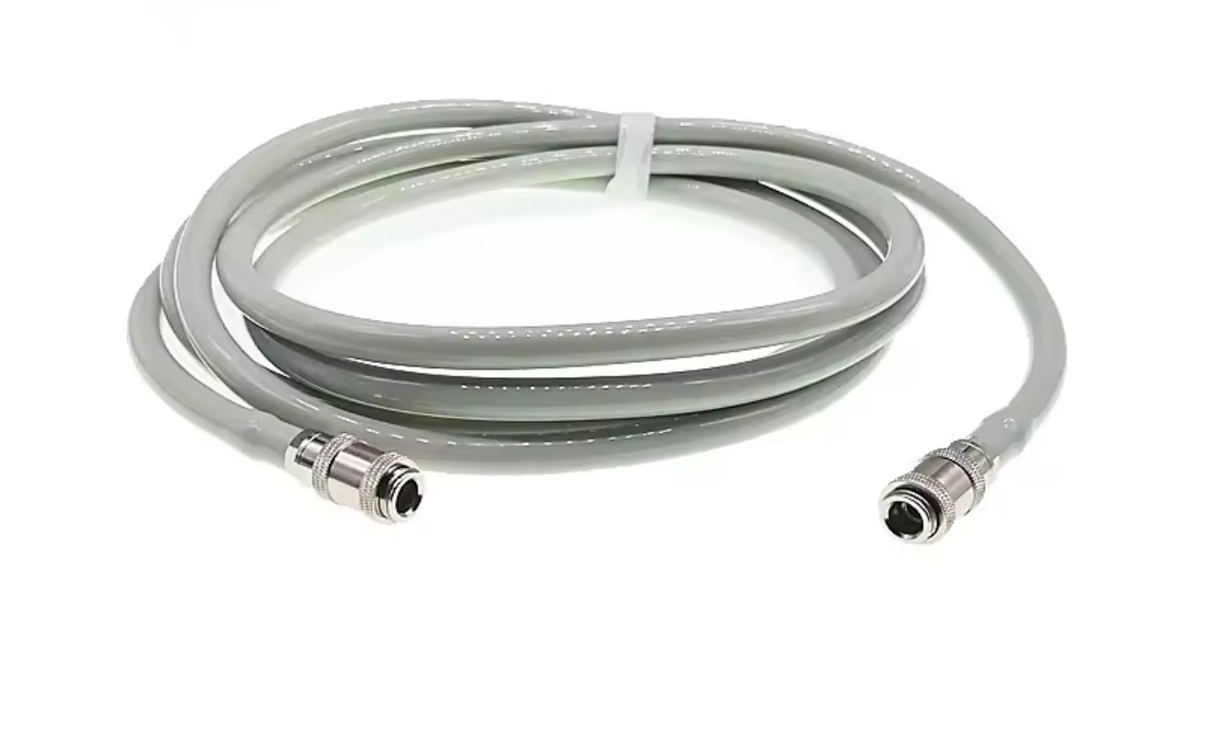Coiled NIBP cable with connectors on a white background