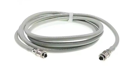 Coiled NIBP cable with connectors on a white background