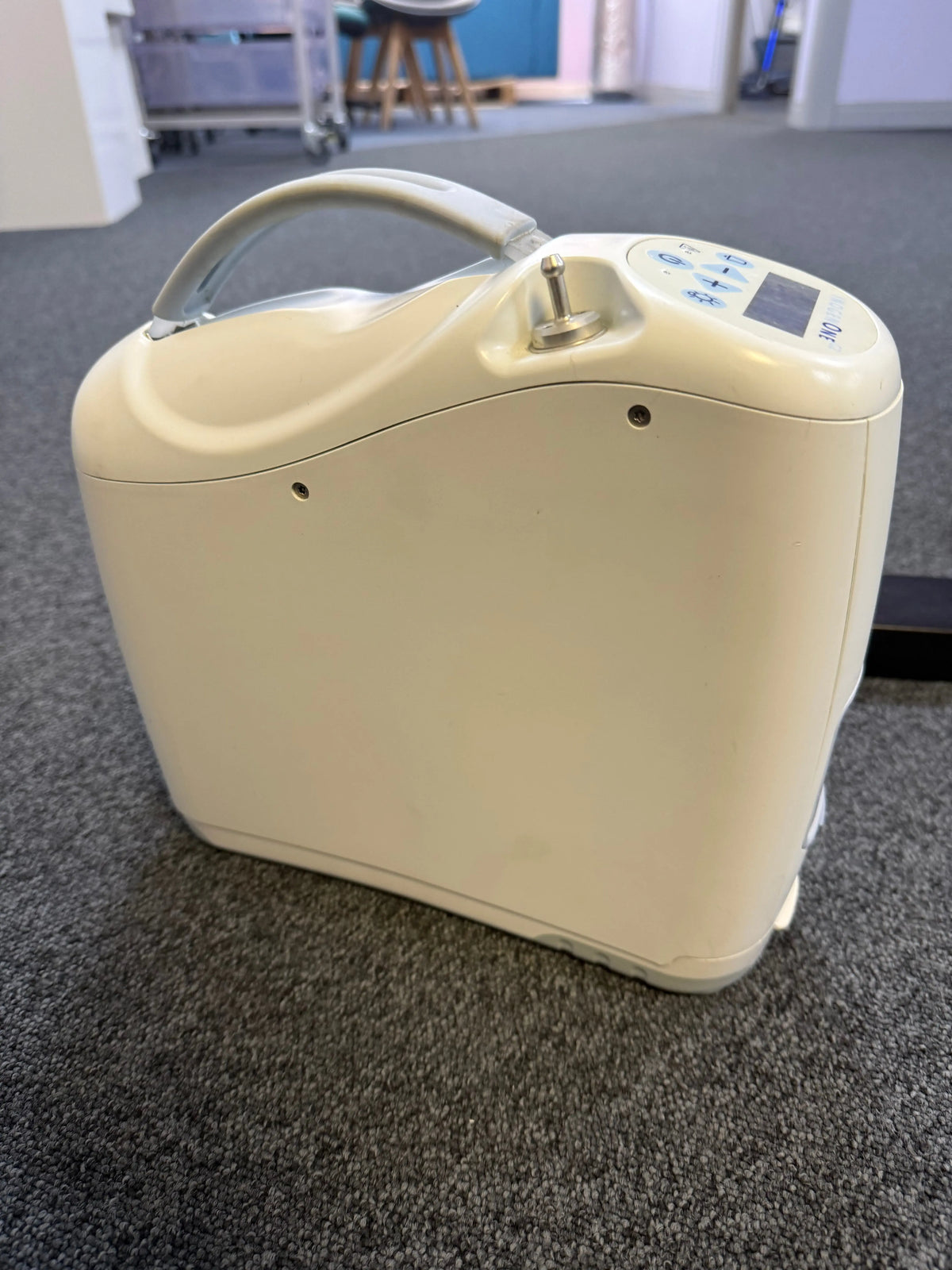 Side view of Inogen G2 unit showing compact size and oxygen ports