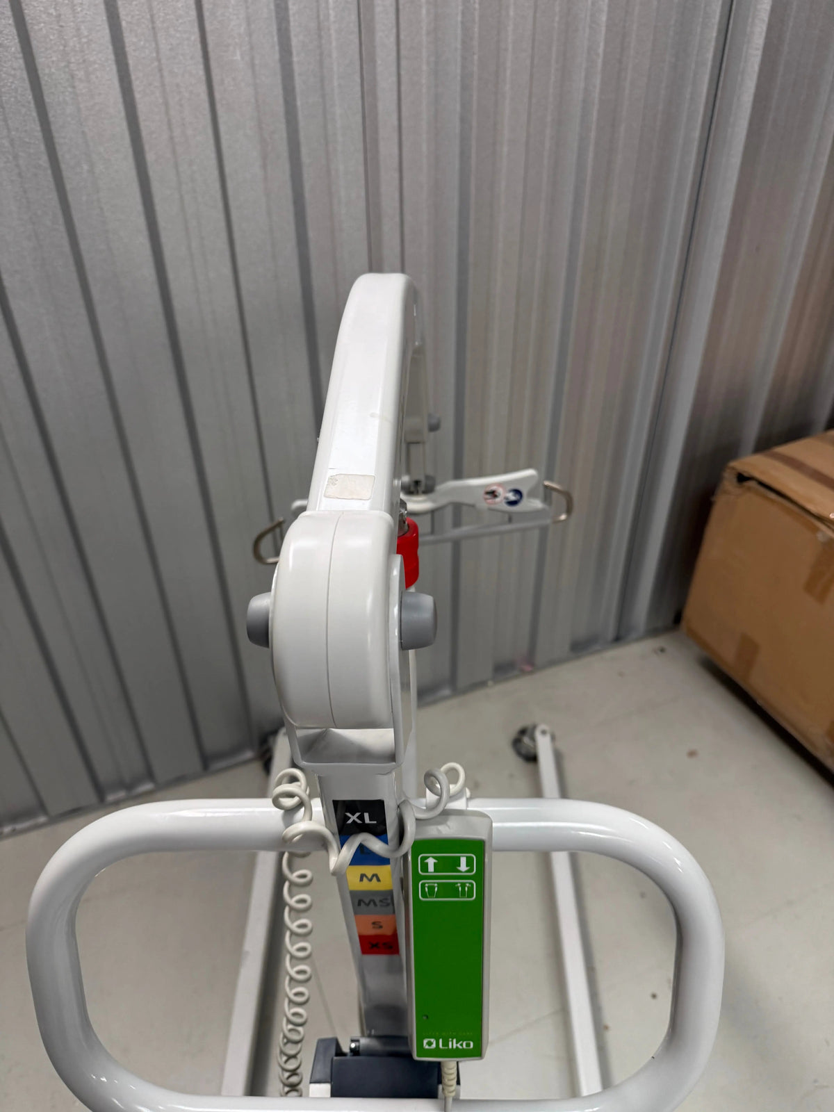 Top view of patient lift showing adjustable leg width