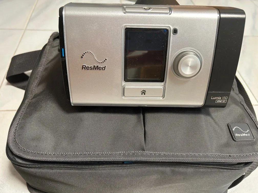 ResMed LUMIS 150 CPAP device on a carrying case