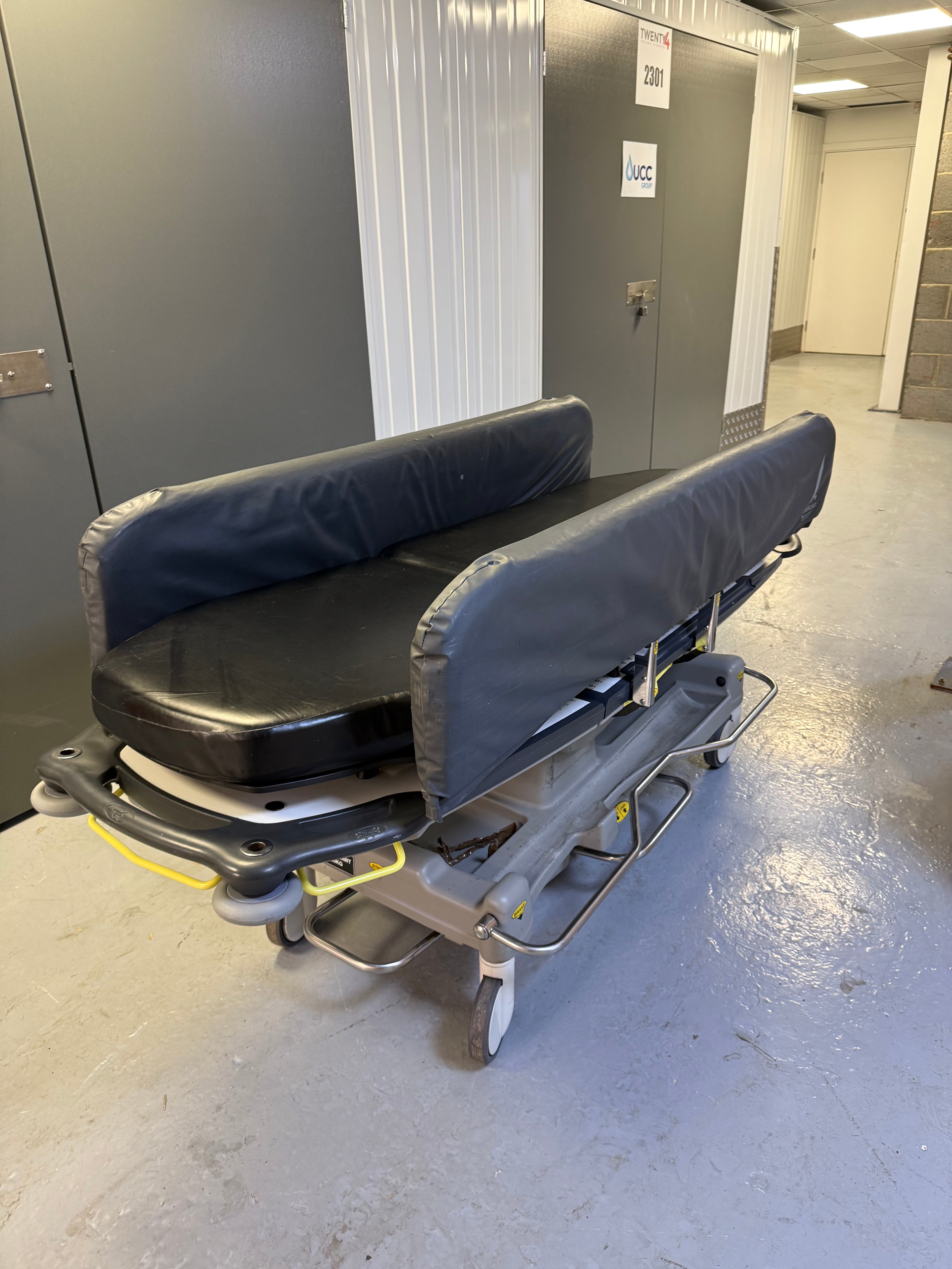 Side view of Anetic Aid QA3 hydraulic Patient Trolley with side rail covers