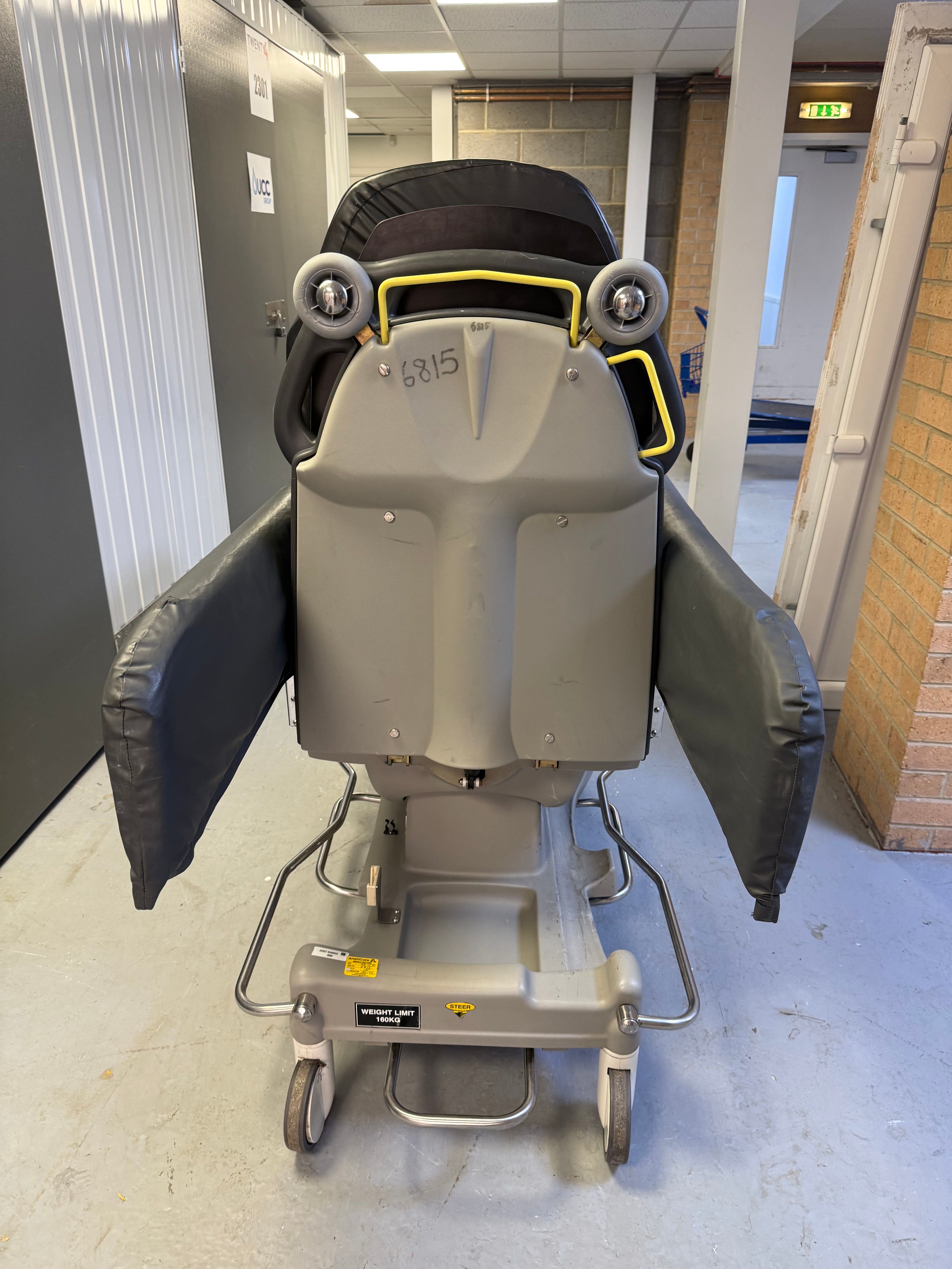 Back view of Anetic Aid QA3 hydraulic Patient Trolley with side rail covers