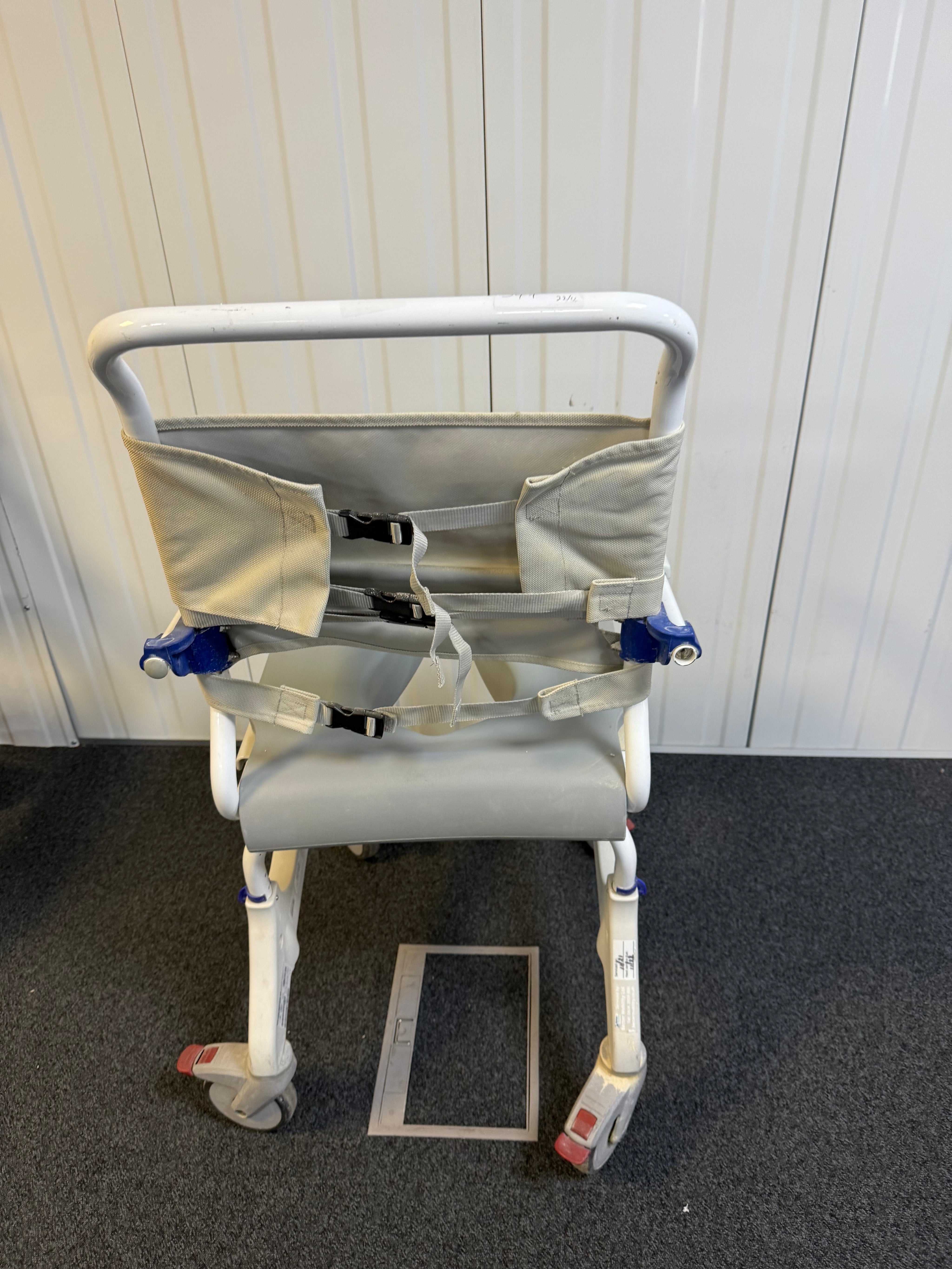 Back view of Aquatec Ocean Ergo XL Shower Commode Chair showcasing stainless steel frame