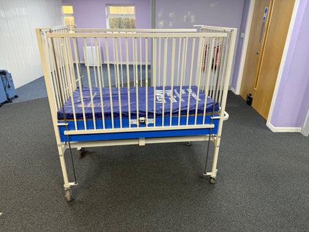 Back view of the infant cot showing its sturdy frame.