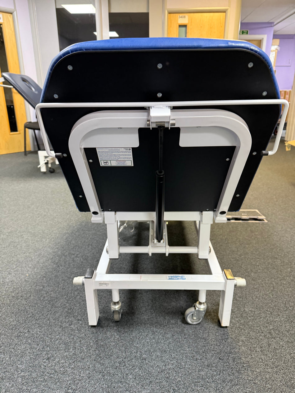 Bristol Maid Electric Examination Couch in raised position with foot controller back view