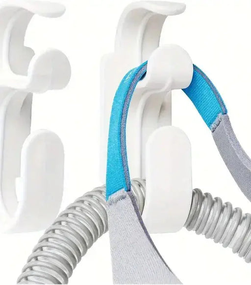 CPAP mask hanger with hose holder for convenient storage