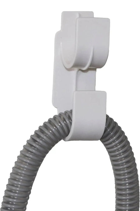 White hose holder with a coiled gray hose on a white background