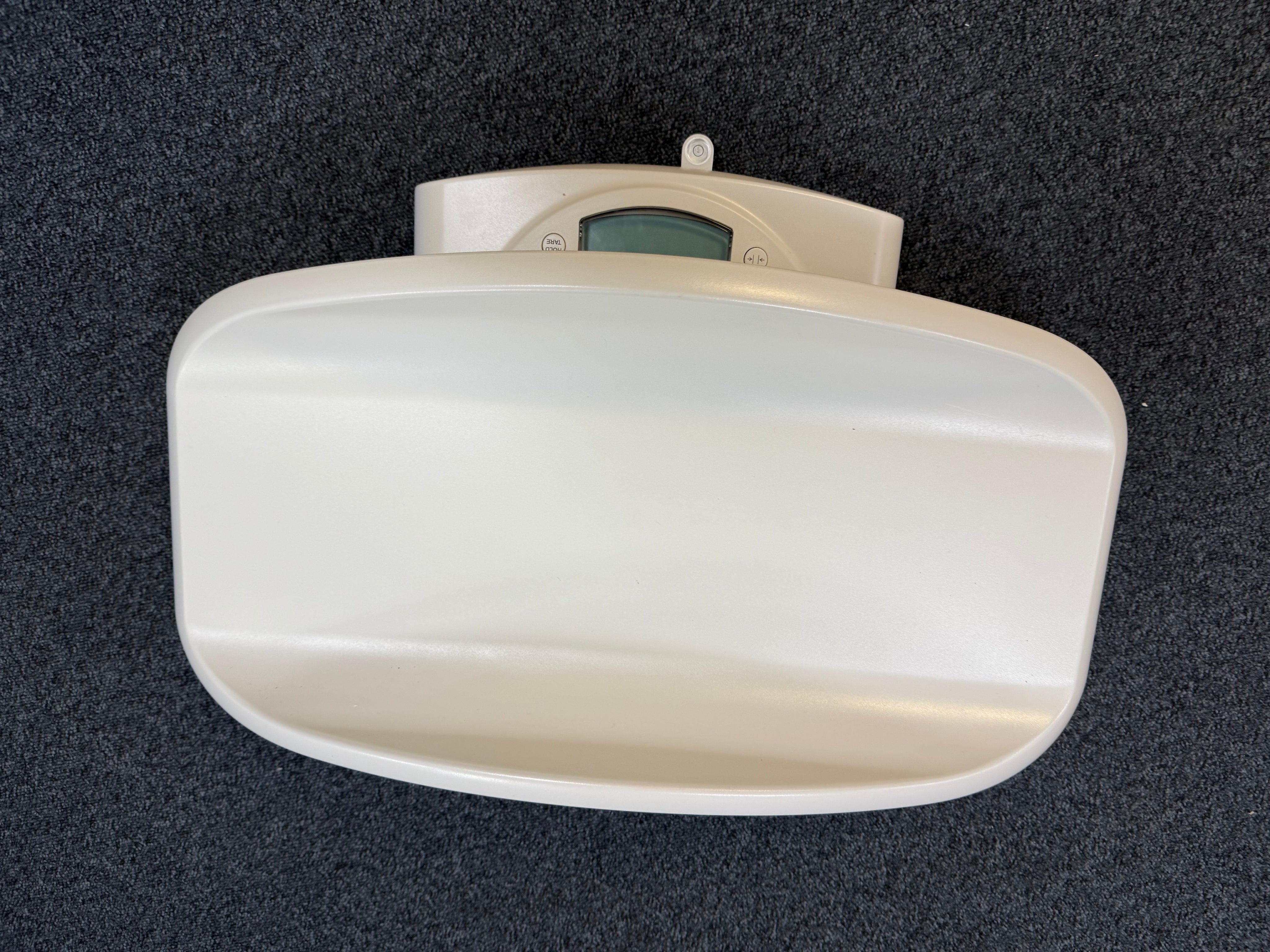 Close-up of Seca 385 digital display showing weight reading