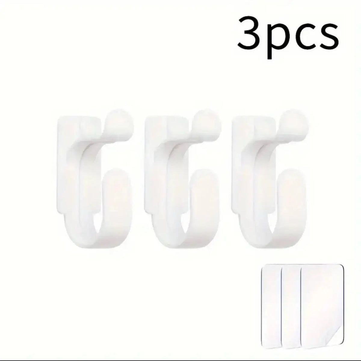Three white hooks with a small adhesive strip on a white background