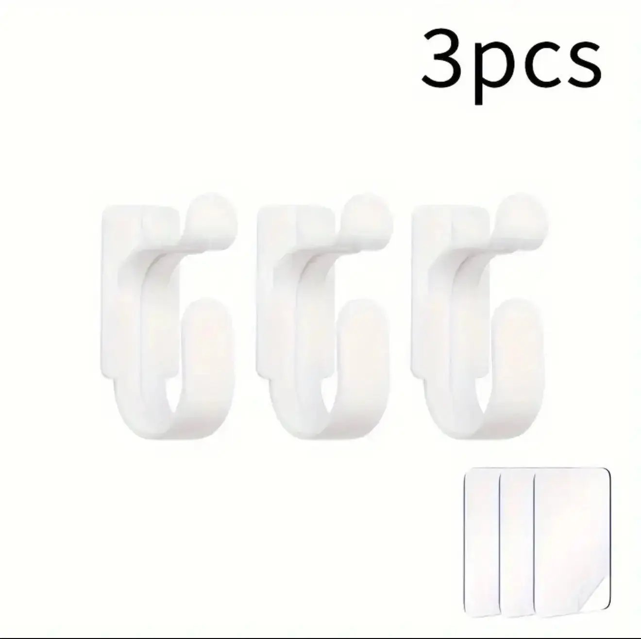 Three white hooks with a small adhesive strip on a white background