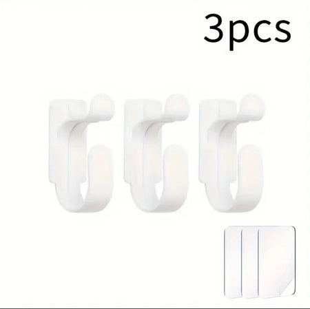 Three white hooks with a small adhesive strip on a white background