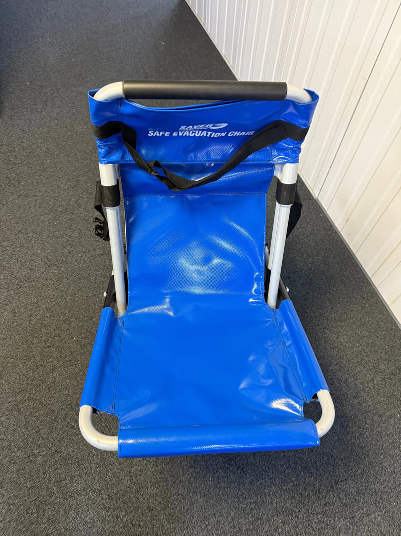 FERNO evacuation chair mounted on wall bracket with dust cover