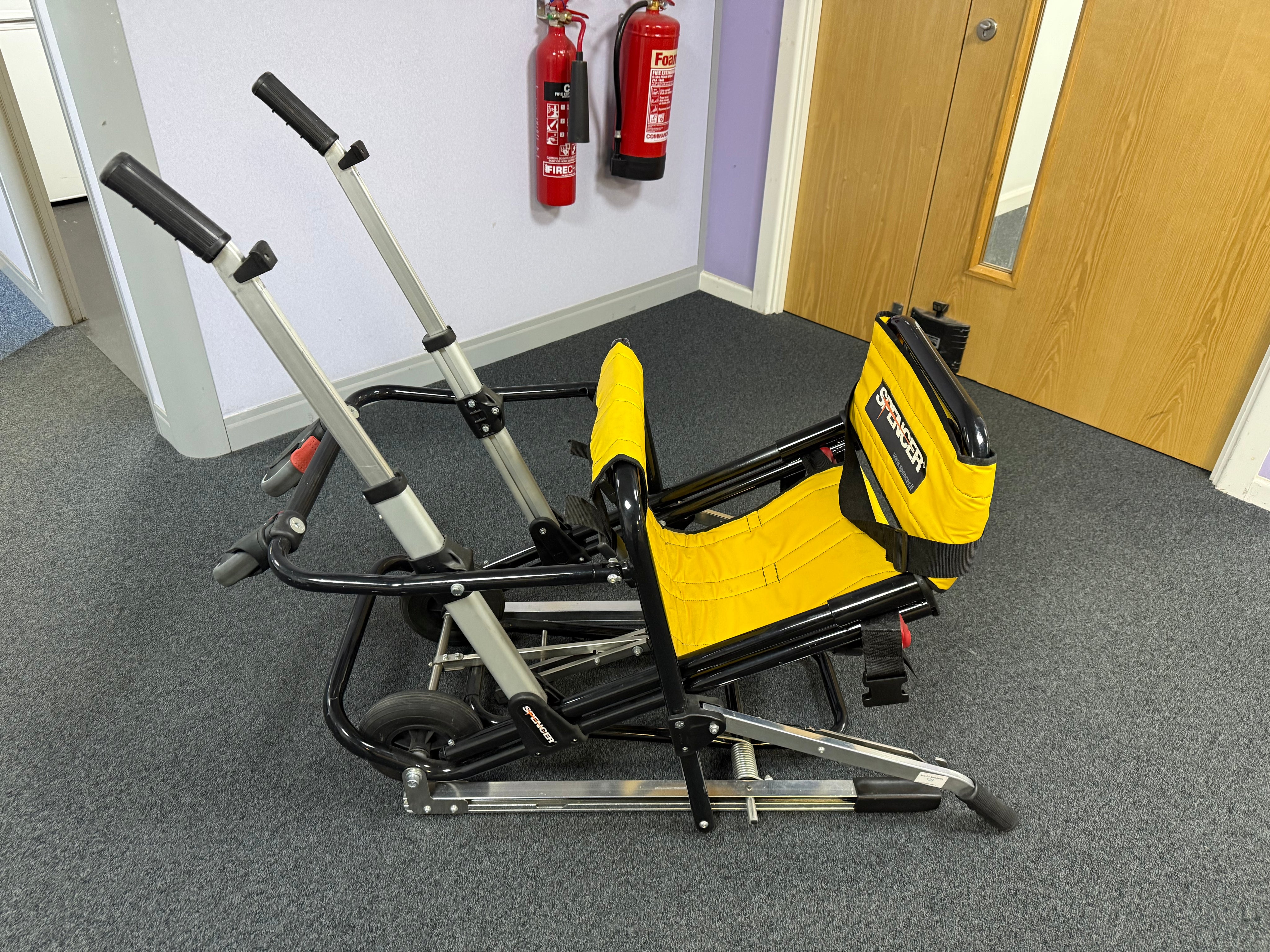 Folded Spencer evacuation chair with transport handles detached