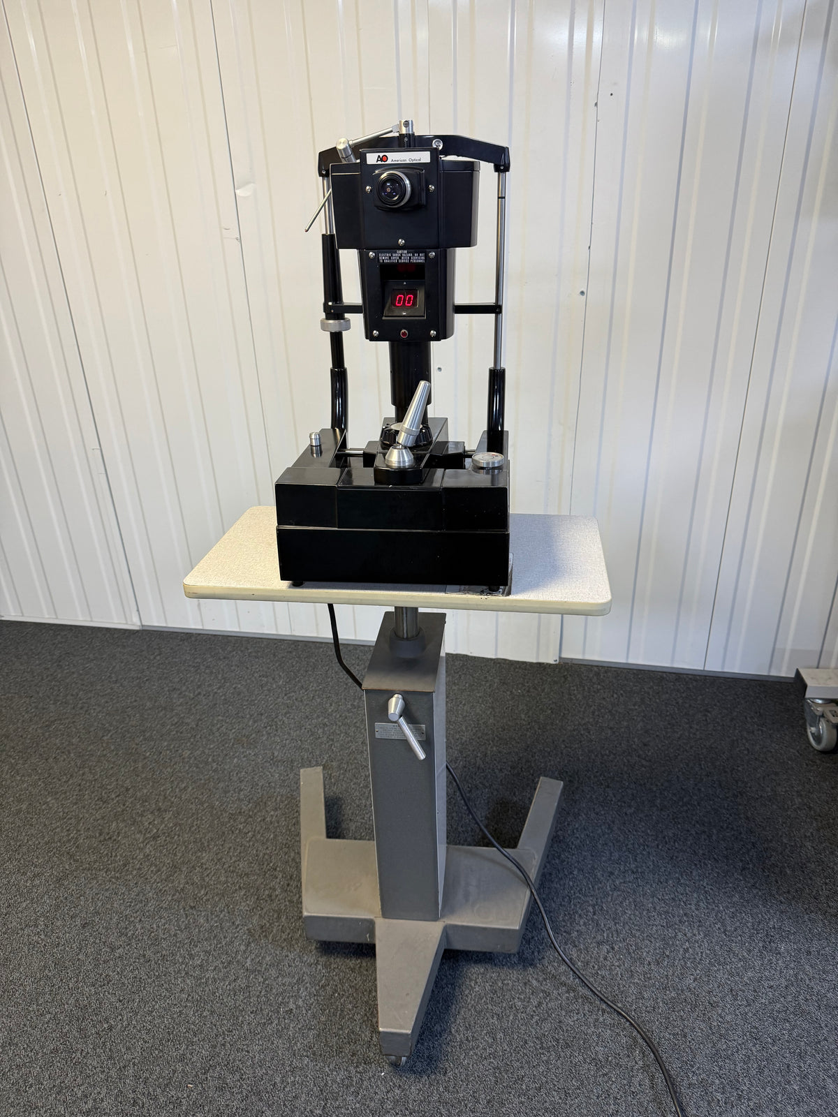 Front view of AO 12415 tonometer mounted on adjustable table
