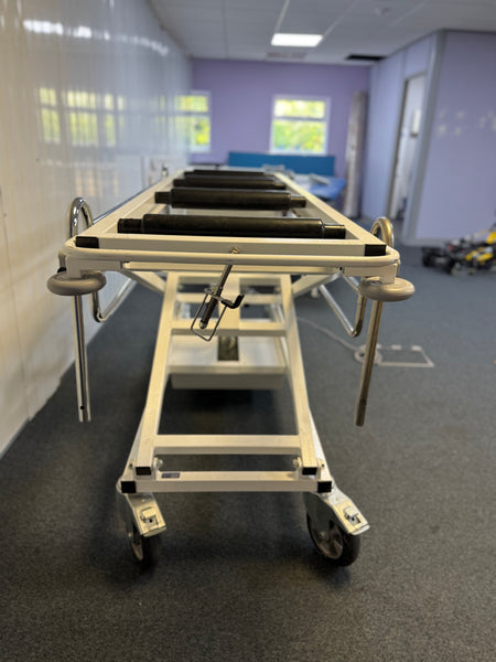 Front view of Electric mortuary table with stainless steel surface and height adjustment controls