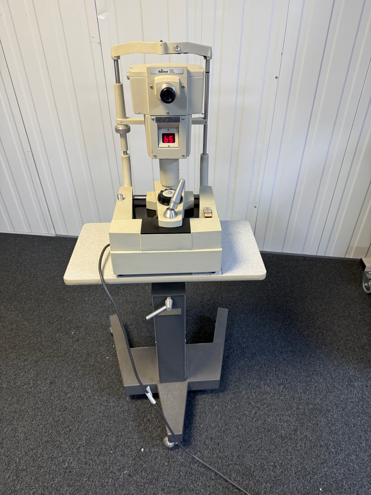 Front view of Reichert 12415 non-contact tonometer with wheeled table
