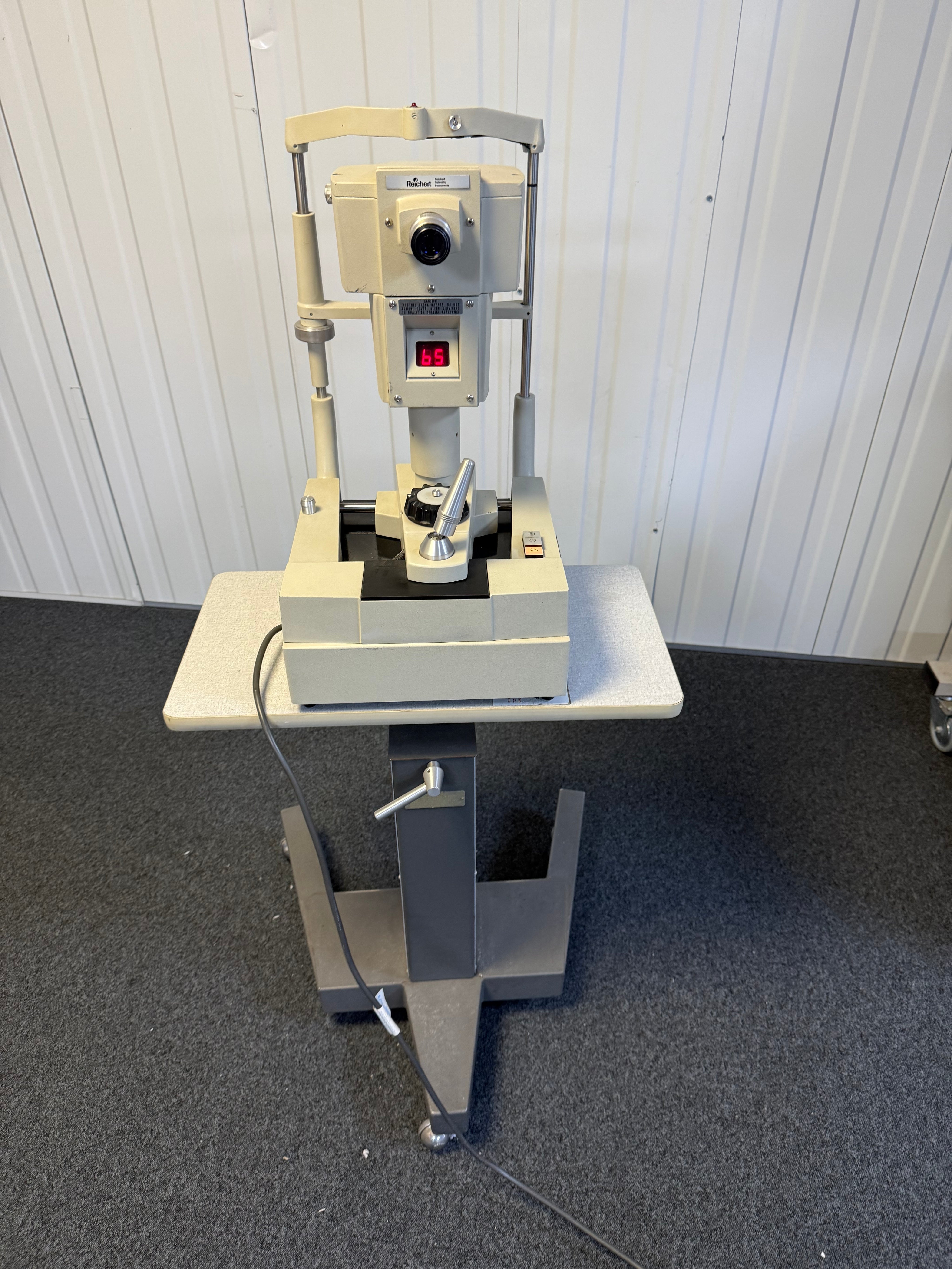 Front view of Reichert 12415 non-contact tonometer with wheeled table