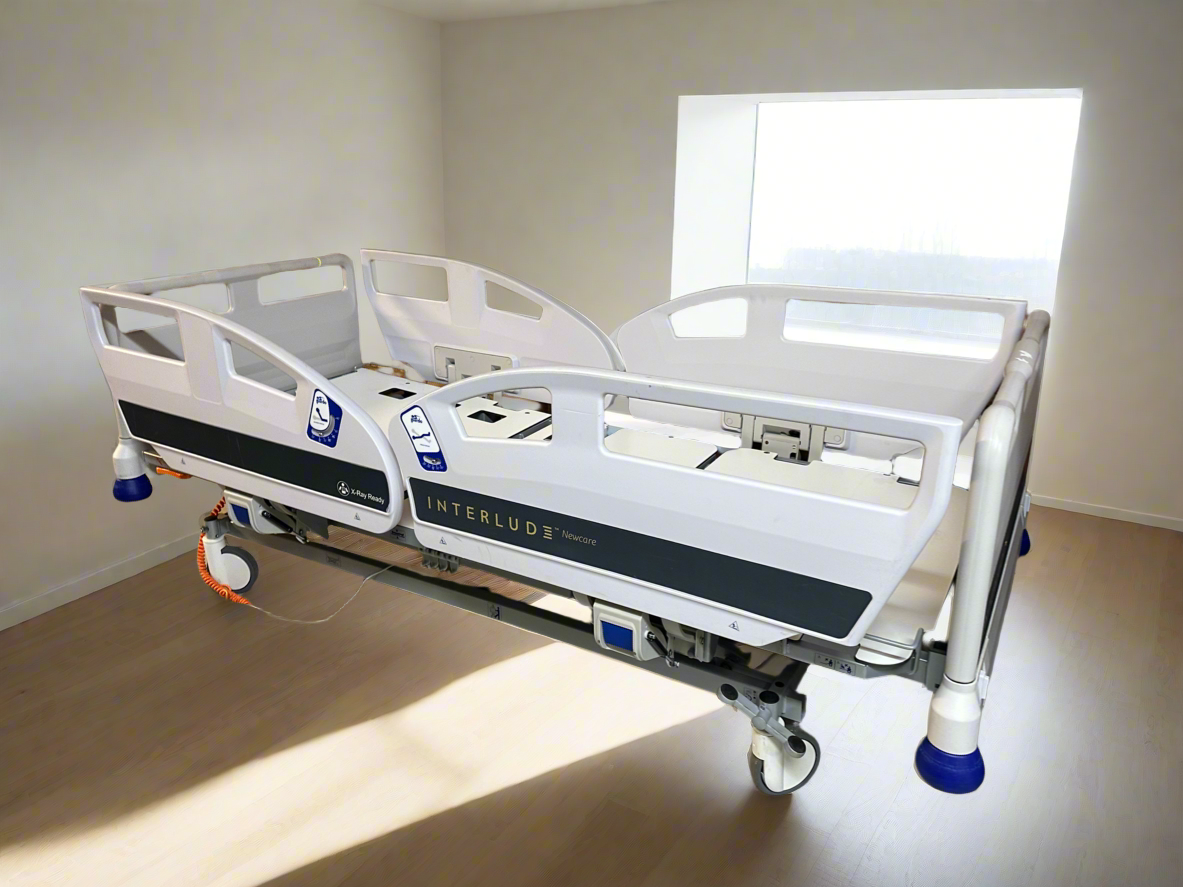 Innova Interlude NewCare V3 electric hospital bed with integrated IV pole and adjustable mattress support.