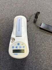 Inogen One G2 oxygen concentrator with LCD control panel and power supply attached