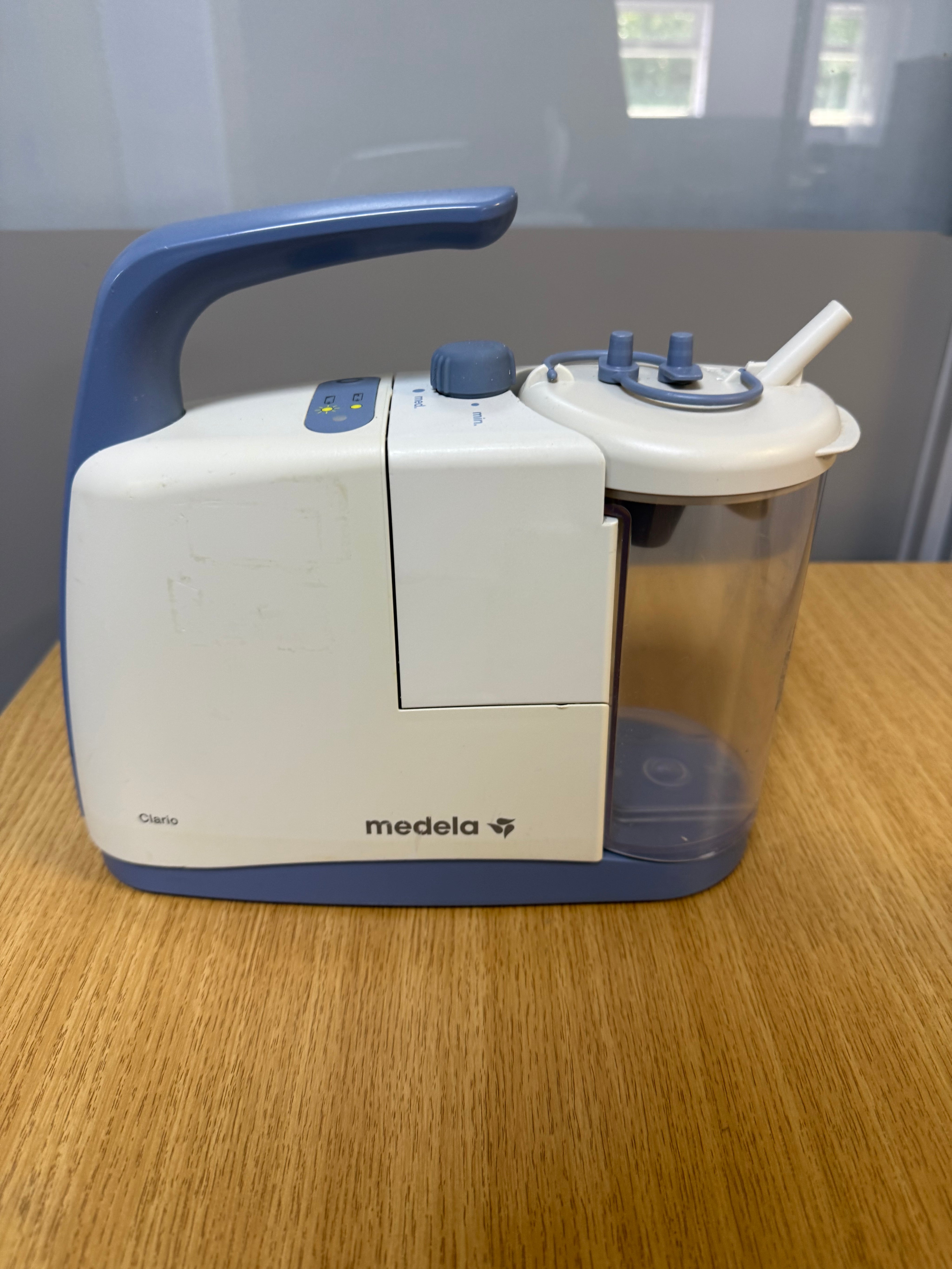 Medela Clario Suction Machine with canister and safety chamber attached