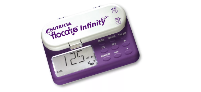 Purple and white medical device with digital display and buttons, branded 'Nutricia flocate Infinity'.
