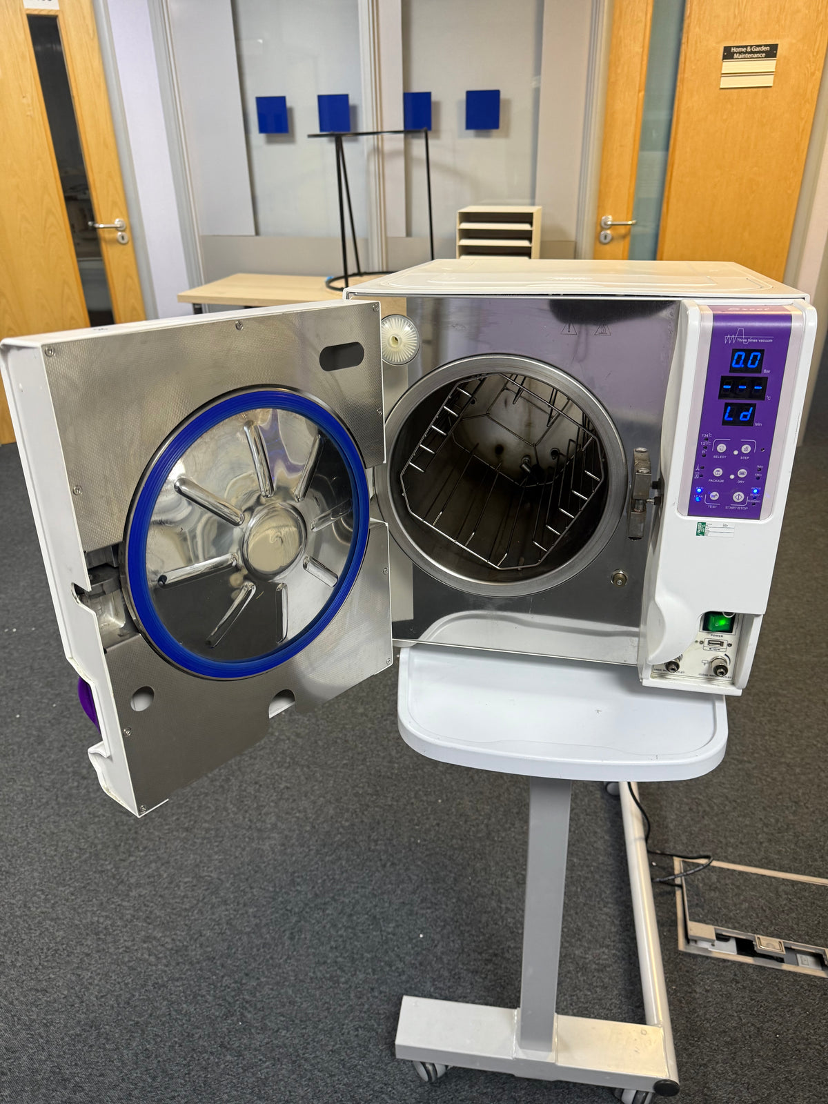 Open chamber of the Enigma Autoclave with sterilisation trays inside