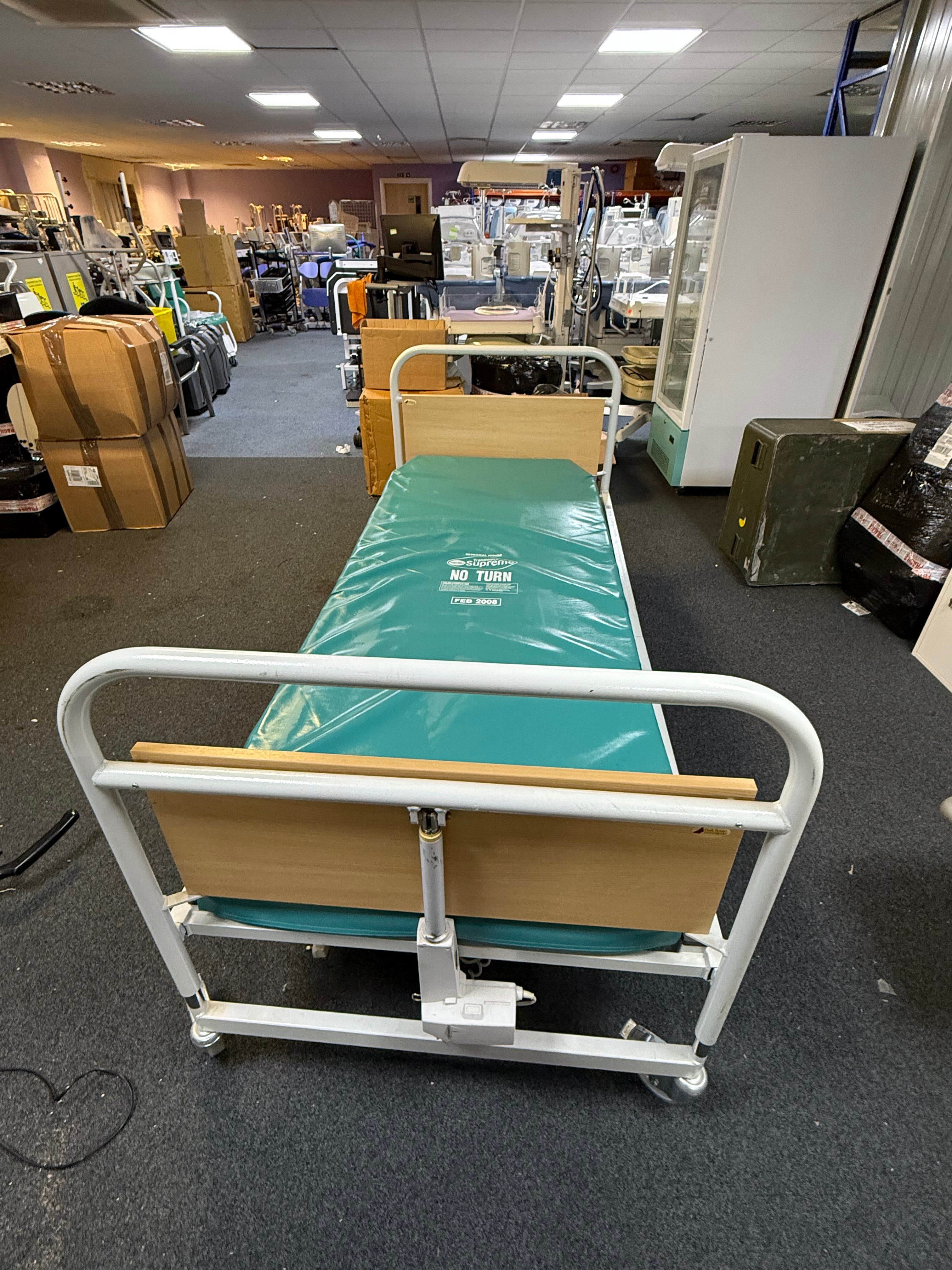 Hospital bed in a hospital room with medical equipment around