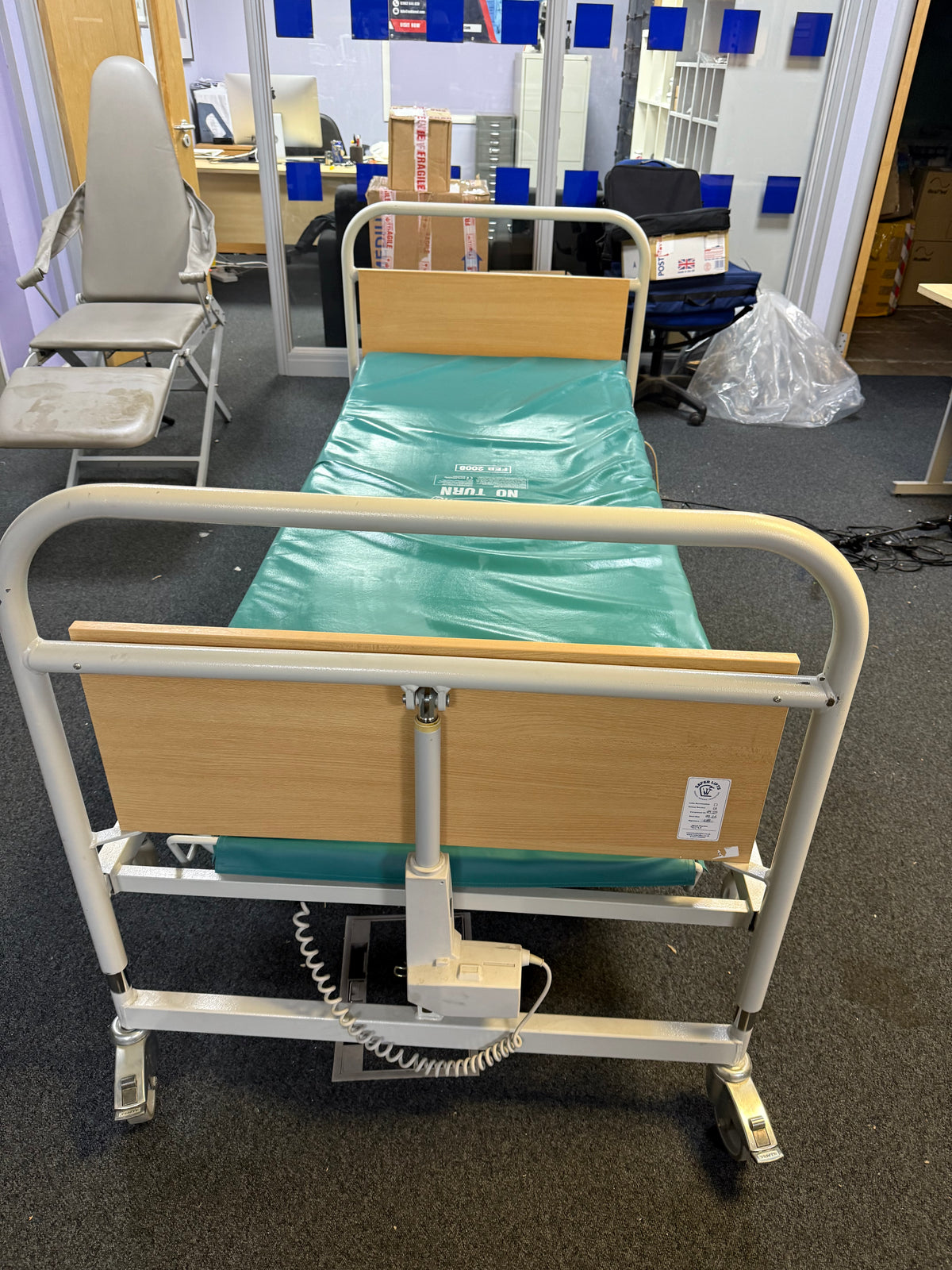 Medical bed with adjustable headboard in a hospital room