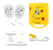 Mini AED Trainer with training pads and packaging on a white background