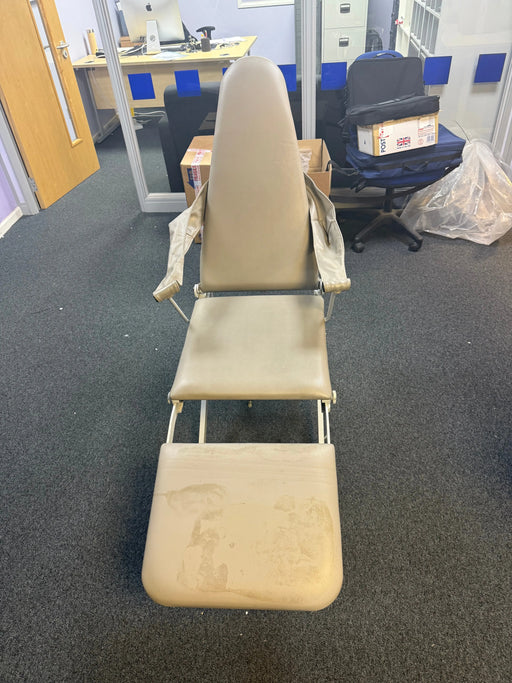 Beige massage chair in a room with gray carpet