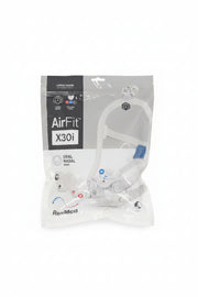 ResMed AirFit X30i oral nasal mask in its original retail packaging, placed on a dark gray textured carpet.