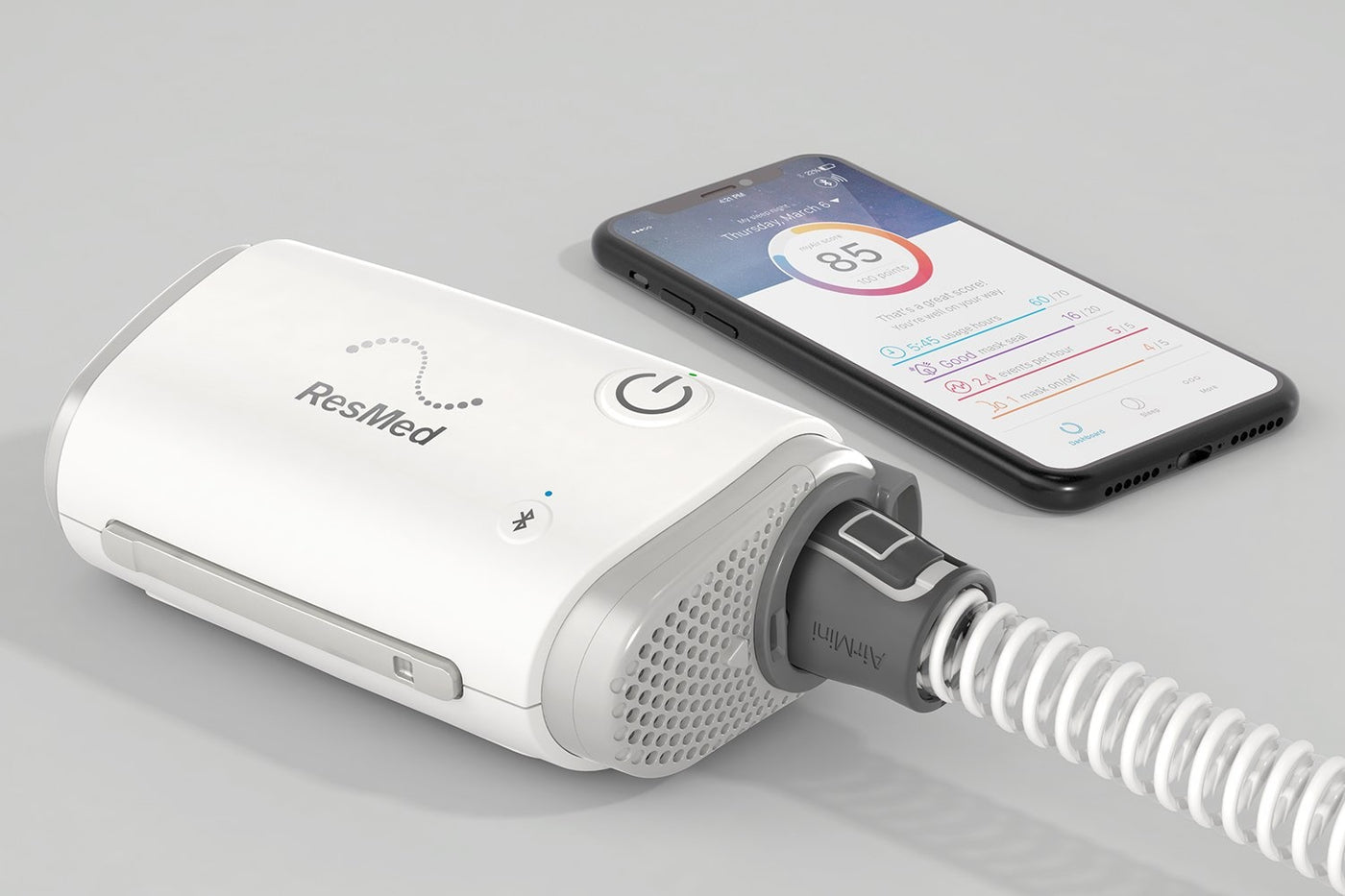 ResMed device with a smartphone displaying app interface on a gray background