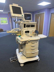 Medical equipment in a room with purple walls and a window.