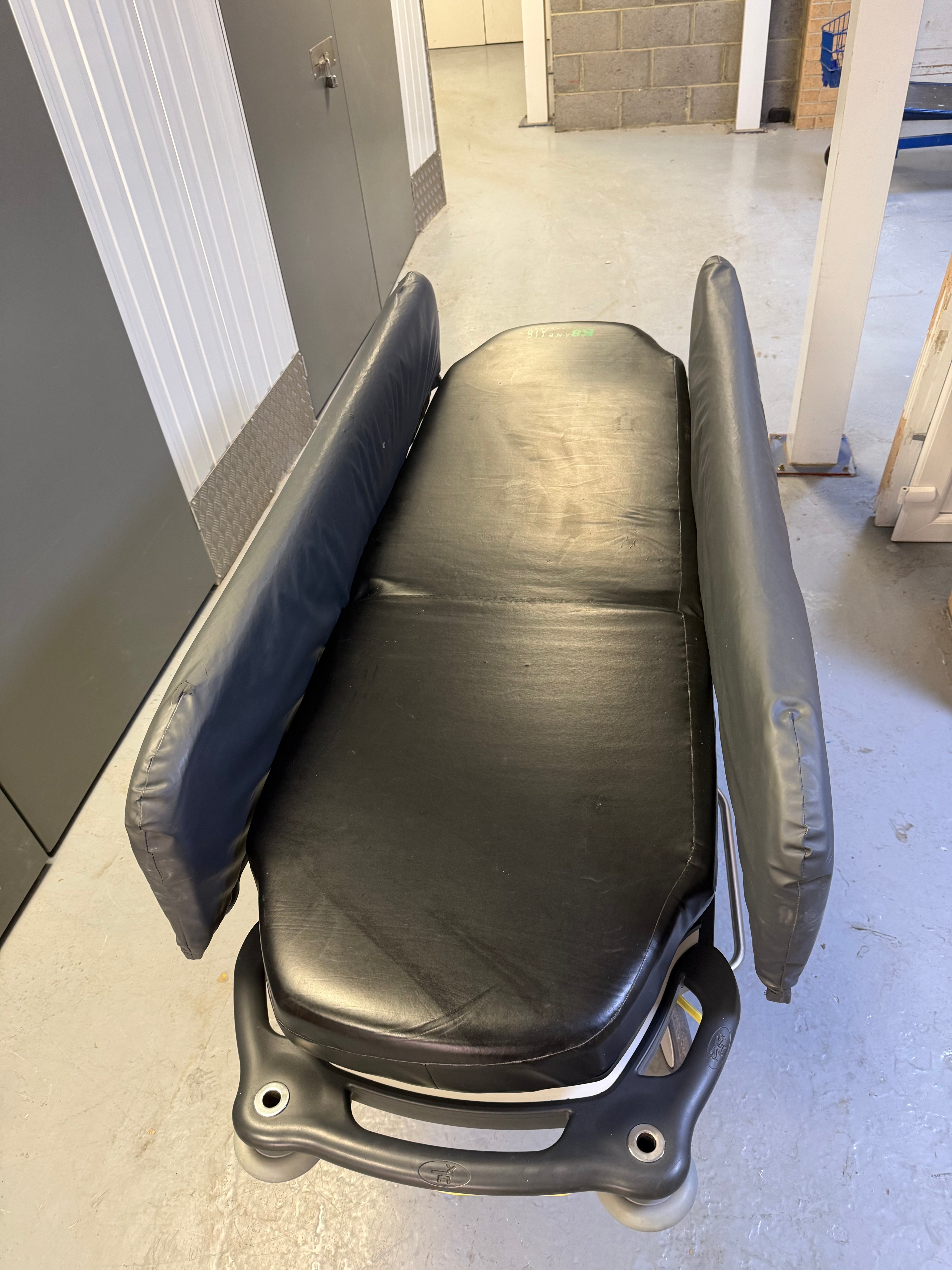 Side view of Anetic Aid QA3 Patient Trolley with side rail covers