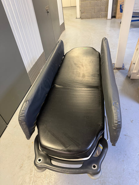 Side view of Anetic Aid QA3 Patient Trolley with side rail covers