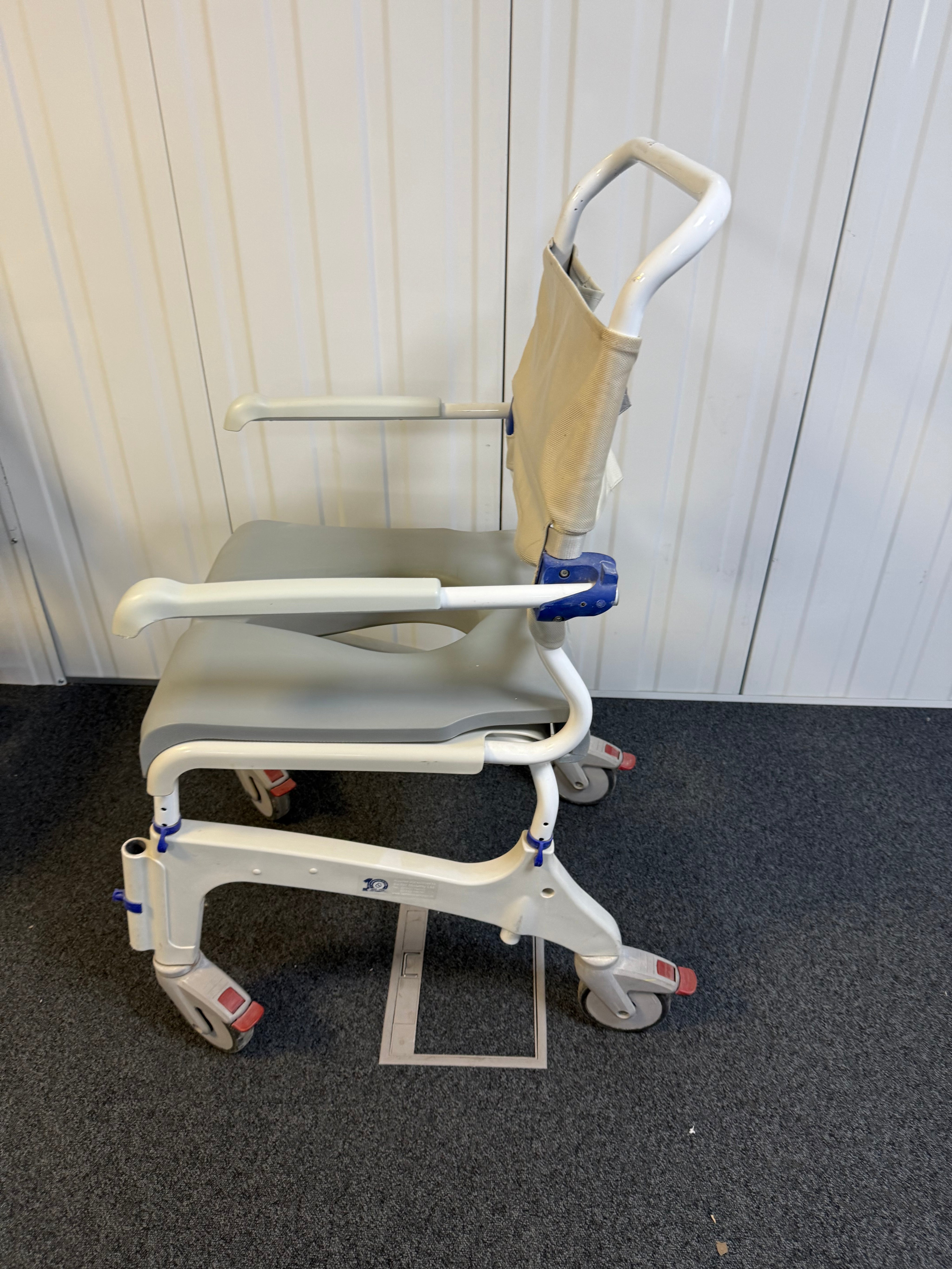 Side view of Aquatec Ocean Ergo XL Shower Commode Chair showcasing stainless steel frame