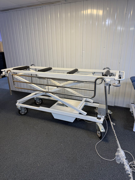 Side view of Electric mortuary table with stainless steel surface and height adjustment controls