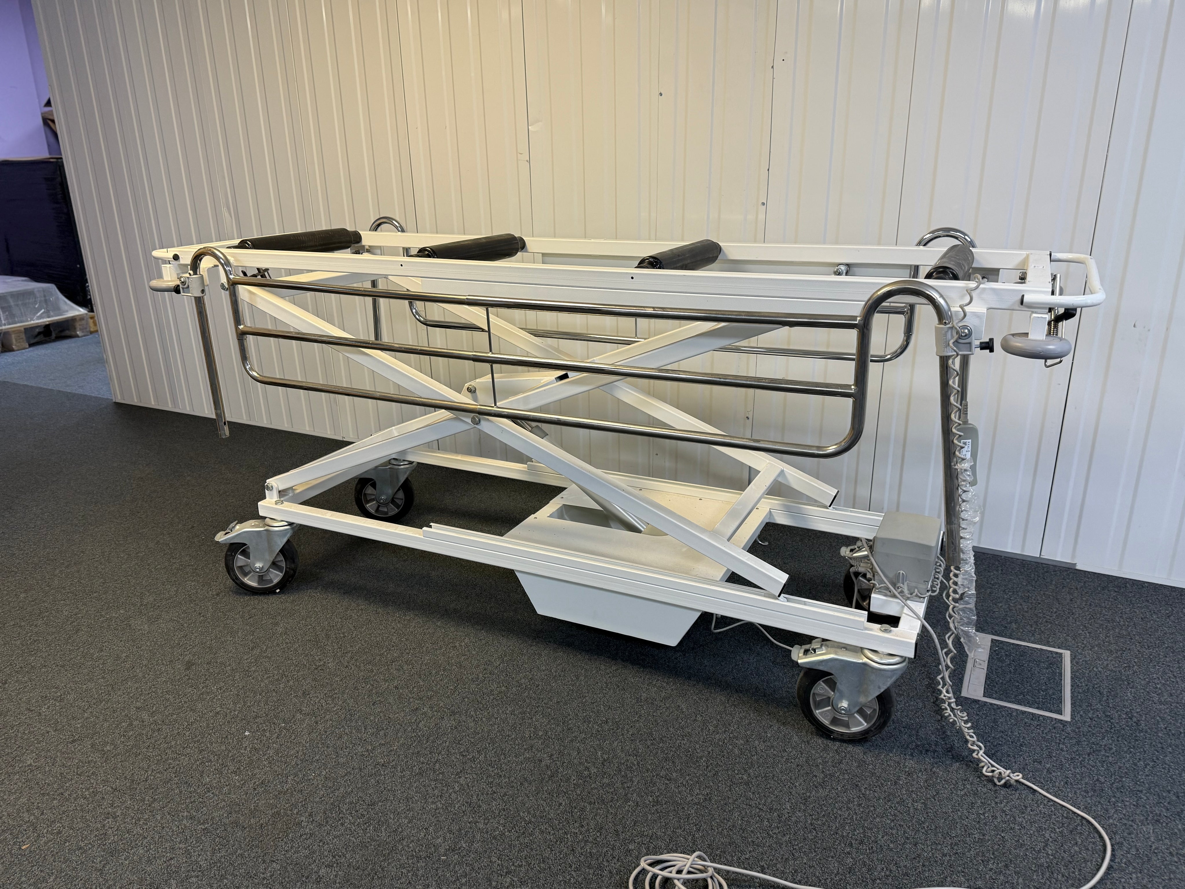 Side view of Electric mortuary table with remote
