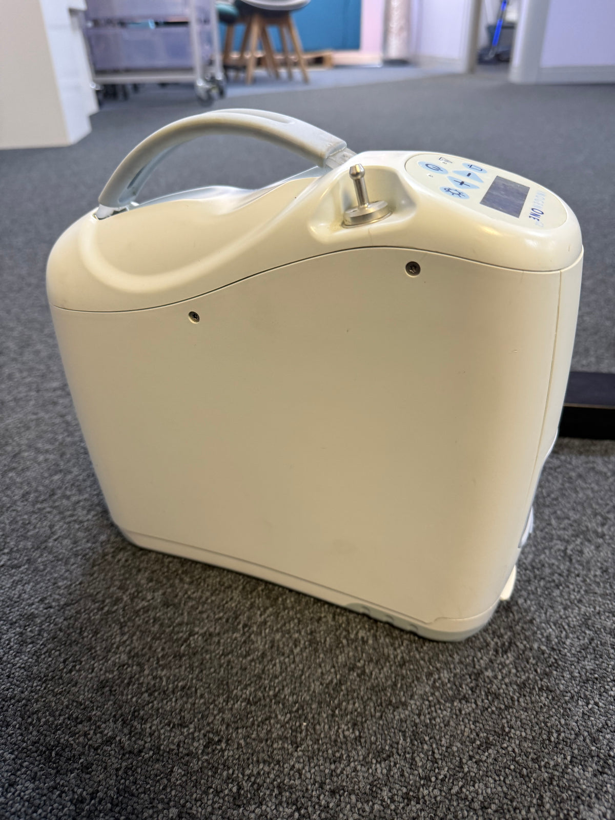Side view of Inogen G2 unit showing compact size and oxygen ports