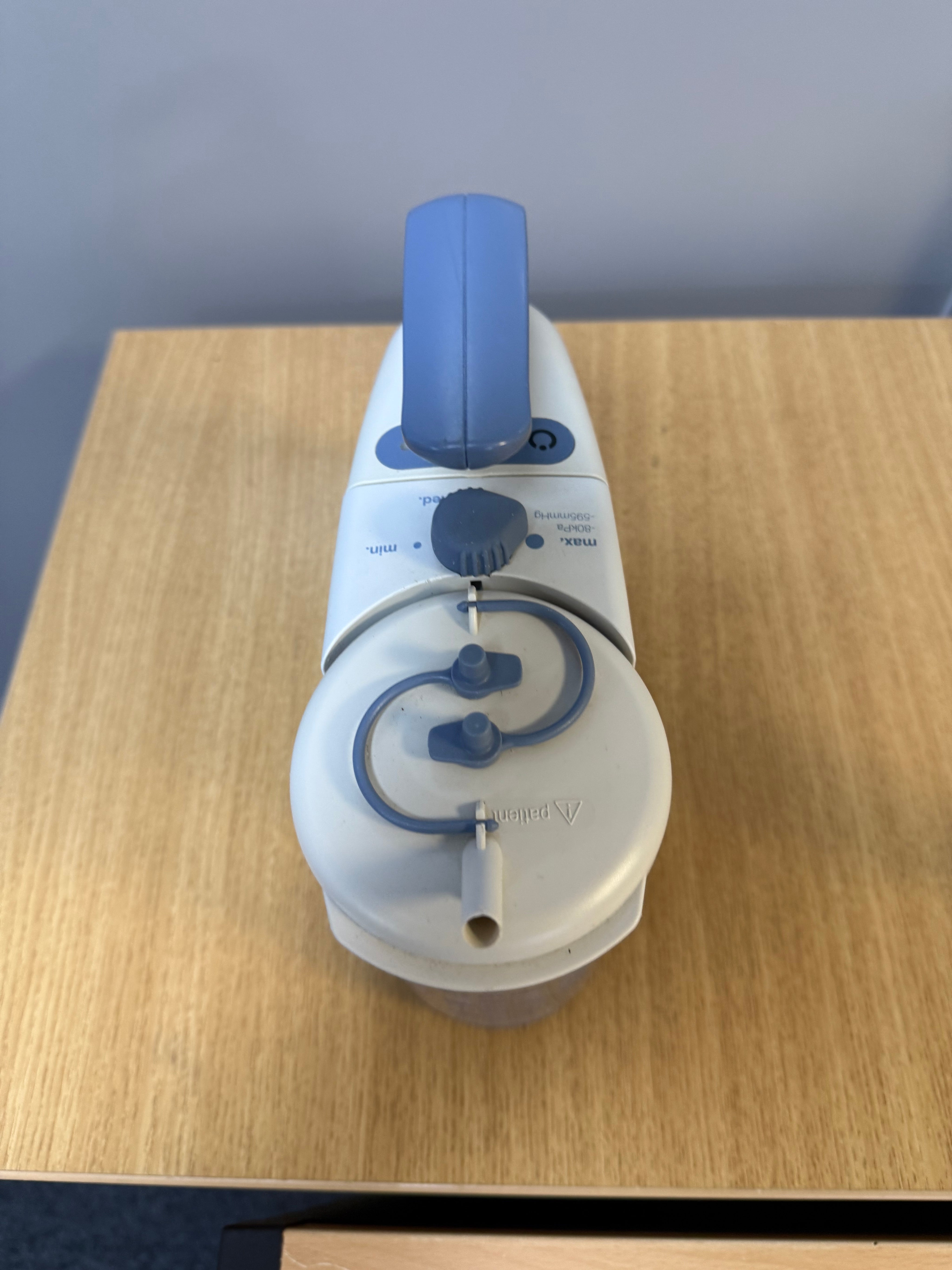 Medela Clario Suction Machine with canister and safety chamber attached