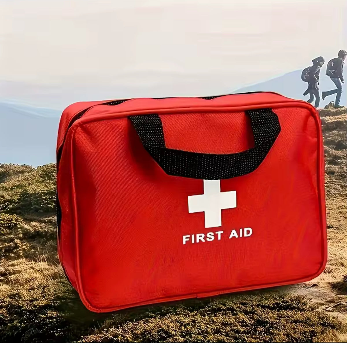 Red first aid kit with a white cross symbol on a natural background