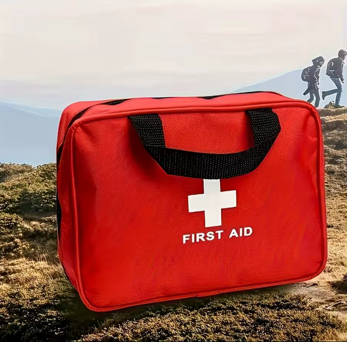 Red first aid kit with a white cross symbol on a natural background